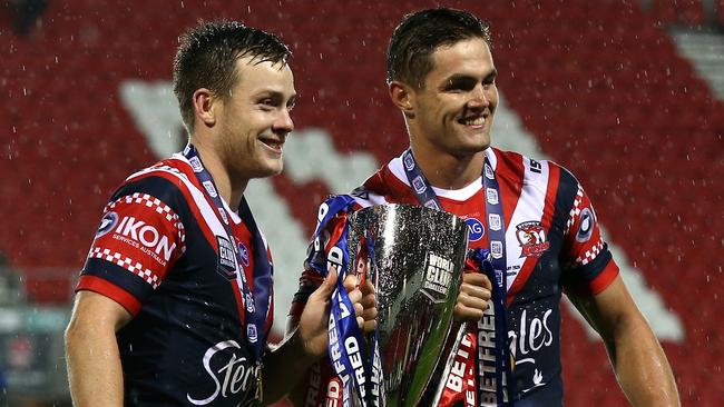 Kyle Flanagan (right) with Luke Keary, is already winning silverware, holding aloft the World Club Challenge trophy. Picture: Lewis Storey/Getty Images