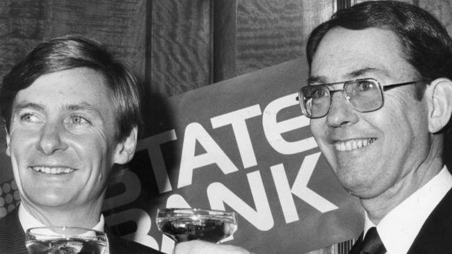 SA Premier John Bannon opens the new State Bank of South Australia in 1984 with a champagne to toast the new bank’s success with the managing director Tim Marcus Clark. Picture: File