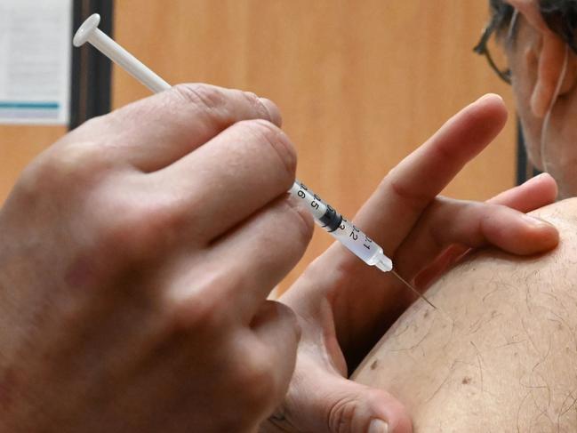 A nurse administers an injection of the Pfizer-BioNtech Covid-19 vaccine to a patient at Zinga Zanga village hall vaccination centre in Beziers, southern France, on March 17, 2021. (Photo by Pascal GUYOT / AFP)