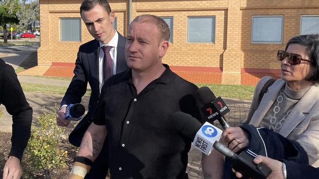 Patrick Patmore, centre, outside court. Picture: Caleb Bond.