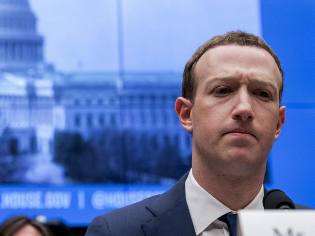 FILE - In this April 11, 2018, file photo, Facebook CEO Mark Zuckerberg pauses while testifying before a House Energy and Commerce hearing on Capitol Hill in Washington about the use of Facebook data to target American voters in the 2016 election and data privacy. Zuckerberg is calling for more outside regulation in several areas in which the social media site has run into problems over the past few years: harmful content, election integrity, privacy and data portability. (AP Photo/Andrew Harnik, File)