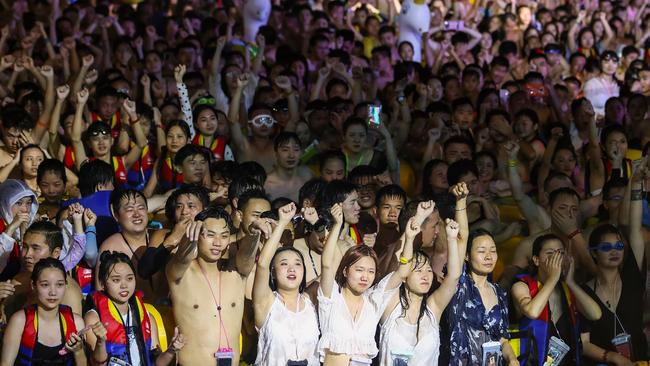 People watching a performance as they cool off in a swimming pool in Wuhan in China's central Hubei province on August 15.