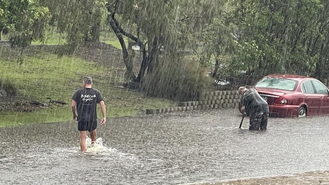 Residents in a northern Gold Coast suburb are out with shovels trying to unblock the drains. Picture: Charlton Hart