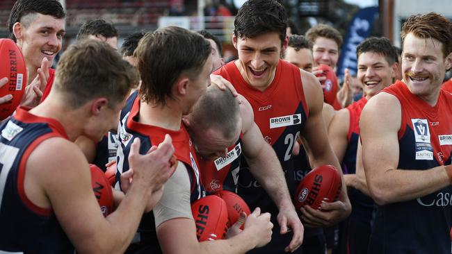 Players celebrate Mitch White of the Casey Demons winning the Norm Goss Medal. Photo: AFL Photos via Getty Images