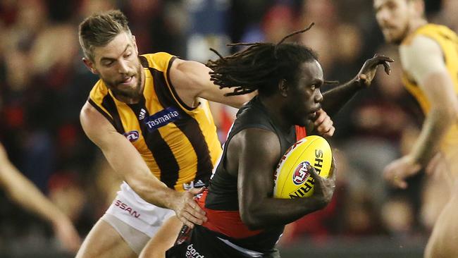 Essendon's Anthony McDonald-Tipungwuti breaks the tackle of Hawthorn’s Ricky Henderson during their match in 2019. Picture: Michael Klein