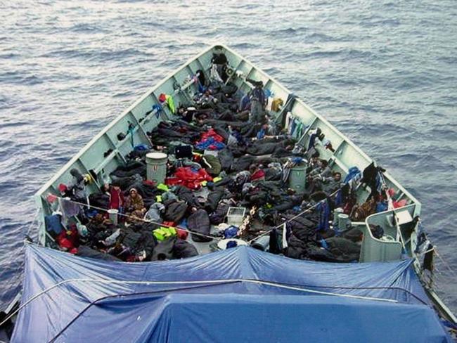 Asylum seekers aboard HMAS Adelaide Australian Naval Ship after being rescued from sinking boat 09 Oct 2001. refugee illegal immigrants