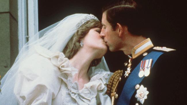 1981: Prince Charles kisses his bride, the former Diana Spencer, on the balcony of Buckingham Palace in London. Picture: AP