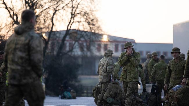 An Australian Army soldier from the 5th Battalion, Royal Australian Regiment, warms his hands during loading of bags and stores onto transport after arriving into the United Kingdom during Operation KUDU. Deploying to the United Kingdom in January 2023, a contingent of up to 70 ADF personnel will join partner nations in the UK-led and based training program for Ukrainian recruits. Picture: File