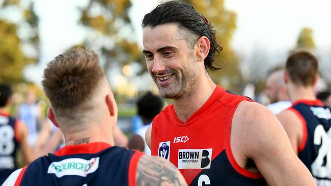 MELBOURNE, AUSTRALIA - AUGUST 27: Brodie Grundy of the Demons speaks with James Harmes after winning the 2023 VFL Wildcard Round match between the Casey Demons and the North Melbourne Kangaroos at Casey Fields on August 27, 2023 in Melbourne, Australia. (Photo by Josh Chadwick/AFL Photos via Getty Images)