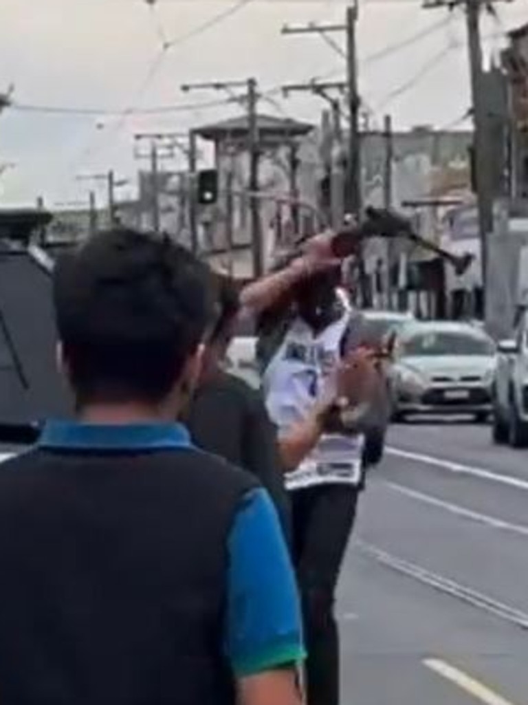 A man was seen swinging a hammer in Melbourne on Monday. Picture: 9News