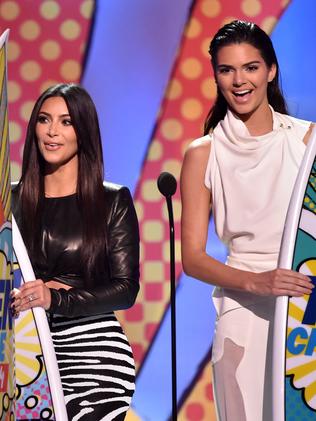 LOS ANGELES, CA - AUGUST 10: (L-R) TV personalities Kylie Jenner, Kim Kardashian, and Kendall Jenner onstage during FOX's 2014 Teen Choice Awards at The Shrine Auditorium on August 10, 2014 in Los Angeles, California. (Photo by Kevin Winter/Getty Images)