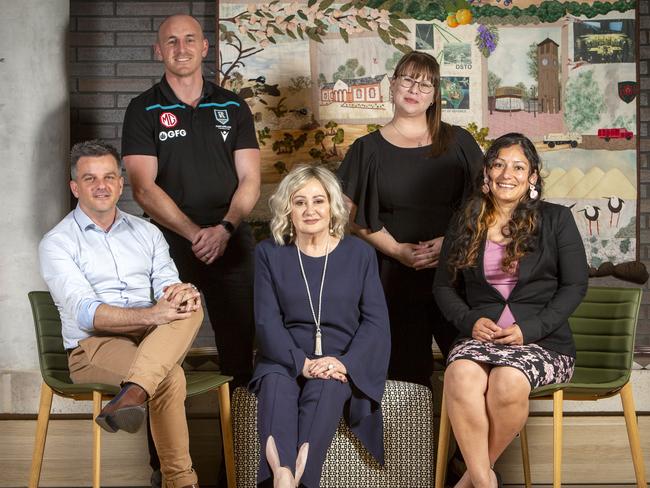 ADELAIDE, AUSTRALIA - NewsWire Photos OCTOBER 19, 2021:  Seated L to R Executive Director White Ribbon Brad Chilcott (blue shirt), Salisbury Mayor Gillian Aldridge (Navy pantsuit), Project Officer Australian Refugee Association Etty Garabelli (Floral skirt). Standing L to R Jake Battifuoco, GM of Power Community Limited (Port Adelaide Football Club) (Black polo) and Team Leader Children's Services North at Relationships Australia SA, Melissa Ruthen (Glasses). Community leaders coming together to tackle disproportionately high rates of DV in the Northern suburbs of Adelaide, SA. Picture Emma Brasier.