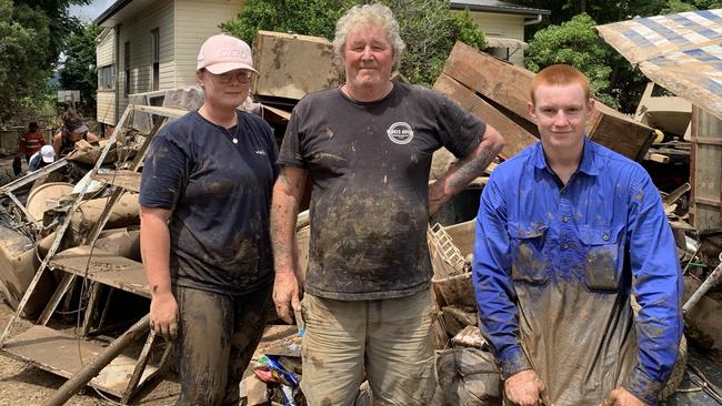 Dannique, David and Daniel Le Van outside David's Railway St home in South Murwillumbah which went completely under in the floods. Picture: Liana Walker