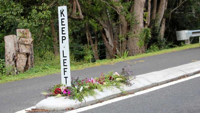 Flowers on Cecil St, Nimbin, where a pedestrian was fatally struck by a vehicle in an alleged hit-and-run incident overnight. Picture: Liana Turner