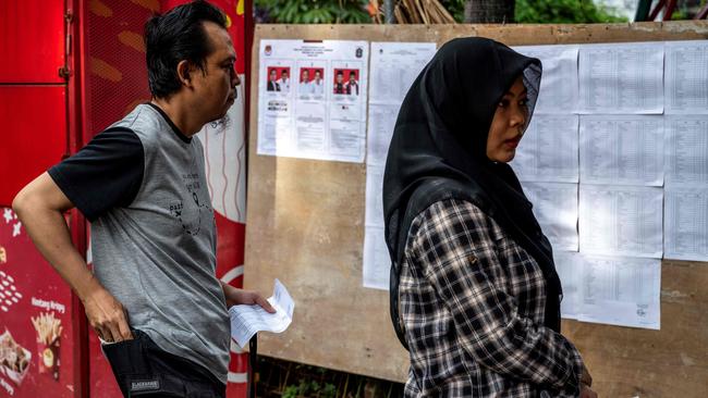 People queue to cast their votes during the simultaneous regional election in Jakarta on Wednesday. Picture: AFP