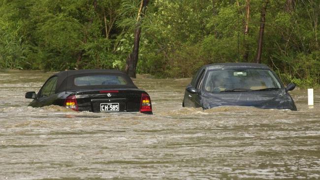 Cars trapped by floodwaters on Wakehurst Parkway in 2003. Picture: John Grainger