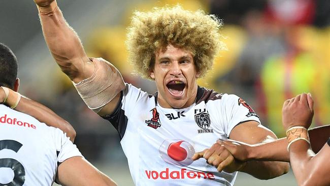 Fiji's Eloni Vunakece (C) celebrates their win with teammates during the Rugby League World Cup quarter-final match between New Zealand and Fiji at Westpac Stadium in Wellington on November 18, 2017. / AFP PHOTO / Marty MELVILLE