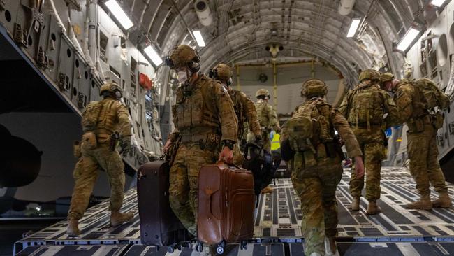 Australian Defence Force personnel unload luggage from a Royal Australian Air Force C-17A Globemaster following an evacuation operation from Kabul.