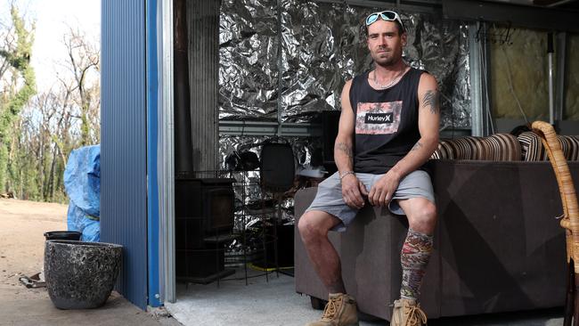 Troy Pauling in the shed he has built for his family to live in on their Yowrie property after losing their home in the New Year's bushfires. Picture: Jonathan Ng