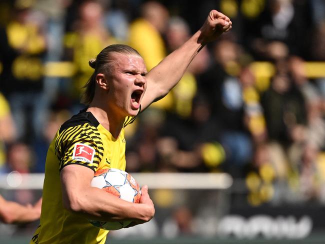 Dortmund's Norwegian forward Erling Braut Haaland (L) celebrates after shooting from the penalty spot to score his team's first goal 1:2 during the German first division Bundesliga football match between Borussia Dortmund and VfL Bochum in Dortmund, western Germany on April 30, 2022. (Photo by INA FASSBENDER / AFP) / DFL REGULATIONS PROHIBIT ANY USE OF PHOTOGRAPHS AS IMAGE SEQUENCES AND/OR QUASI-VIDEO