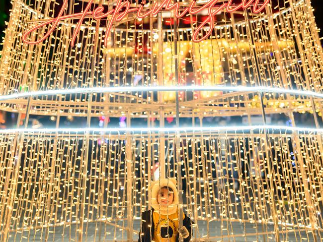 A child poses with light decorations at Sishane Square in Istanbul on December 31, 2024. Picture: AFP