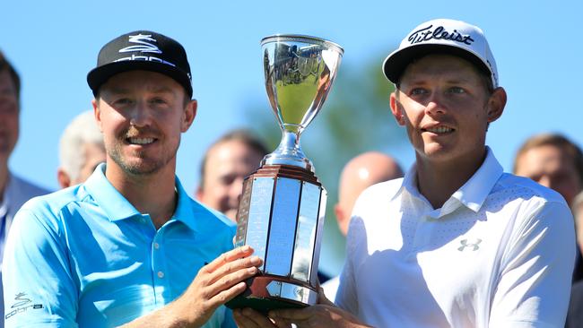 (L-R) Jonas Blixt of Sweden and Cameron Smith of Australia pose with the trophy after winning in a sudden-death playoff during a continuation of the final round of the Zurich Classic.