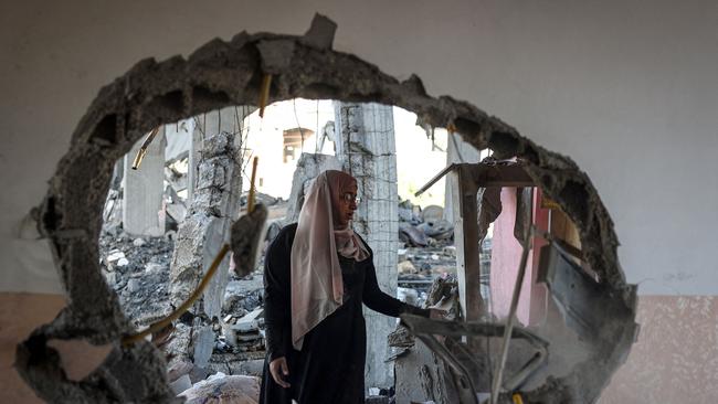 A Palestinian woman checks the rubble of a home hit by overnight Israeli bombing in Rafah in the southern Gaza Strip on April 20. Picture: AFP