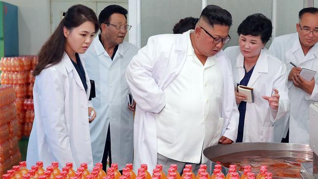 North Korean leader Kim Jong-un and wife Ri Sol-ju, left, inspect the Songdowon General Foodstuff Factory in Kangwon province. Picture: AFP
