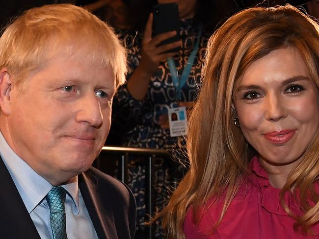 (FILES) In this file photo taken on October 02, 2019 Britain's Prime Minister Boris Johnson leaves with his partner Carrie Symonds after delivering his keynote speech to delegates on the final day of the annual Conservative Party conference at the Manchester Central convention complex, in Manchester, north-west England. - British Prime Minister Boris Johnson was discharged from hospital on April 12, 2020, a Downing Street spokesman said, a week after being admitted for treatment for coronavirus and spending three days in intensive care. "The PM has been discharged from hospital to continue his recovery, at Chequers," the spokesman said, referring to the prime minister's country estate outside London. "On the advice of his medical team, the PM will not be immediately returning to work." (Photo by Jeremy Selwyn / POOL / AFP)