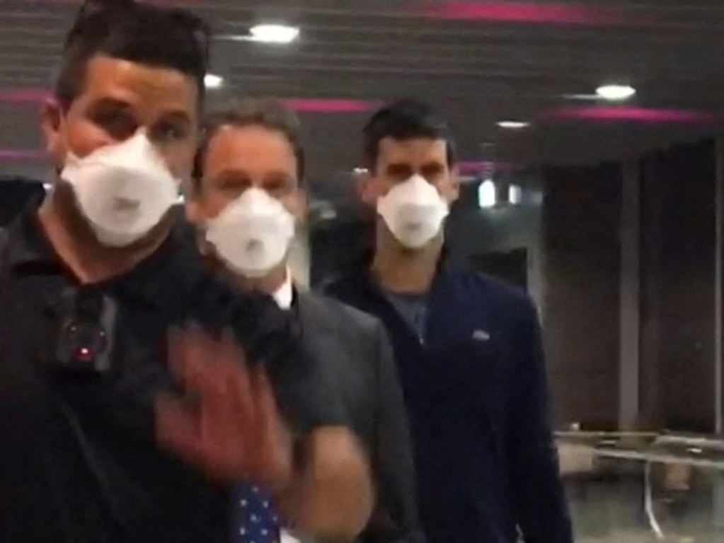 This screen grab taken from AFP TV shows Novak Djokovic (right) preparing to depart from Melbourne Airport in Melbourne on January 16, 2022. Picture: Mell Chun/AFP