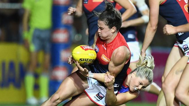 Harriet Cordner of the Demons is tackled by Katie Brennan of the Bulldogs.