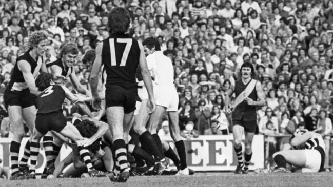 Footballer Brian Cunningham (top right) is down and his adversary, Wayne Phillis, has disappeared under a heap of players after the clash sparked a melee involving 28 players. SANFL football - Port Adelaide vs Glenelg second semi-final match at Football Park 12 Sep 1976. (Pic by staff photographer Bryan Charlton)