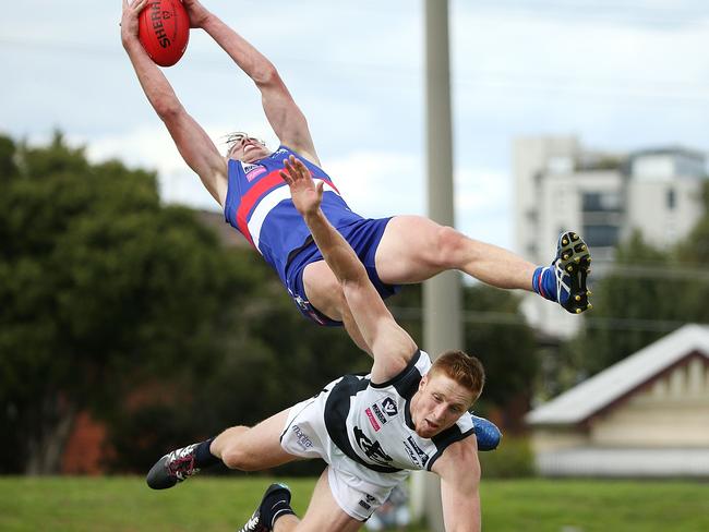 MELBOURNE, AUSTRALIA - APRIL 10: Mitch Hannan of the Footscray Bulldogs (L) takes a mark over Matthew Dick of the Northern Blues during the round one VFL match between the Footscray Bulldogs and the Northern Blues at Whitten Oval on April 10, 2016 in Melbourne, Australia. (Photo by Jack Thomas/Getty Images)