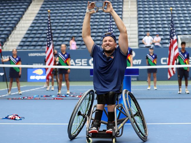 NEW YORK, NEW YORK - SEPTEMBER 12: Dylan Alcott of Australia celebrates with the championship trophy after defeating Niels Vink of the Netherlands to complete a 'Golden Slam' during their Wheelchair Quad Singles final match on Day Fourteen of the 2021 US Open at the USTA Billie Jean King National Tennis Center on September 12, 2021 in the Flushing neighborhood of the Queens borough of New York City.  (Photo by Elsa/Getty Images)