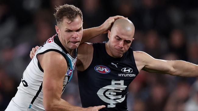 MELBOURNE, JULY 26, 2024: 2024 AFL Football - Round 20 - Carlton Blues V Port Adelaide Power at Marvel Stadium. Alex Cincotta of the Blues and Dan Houston of the Power  in action. Picture: Mark Stewart