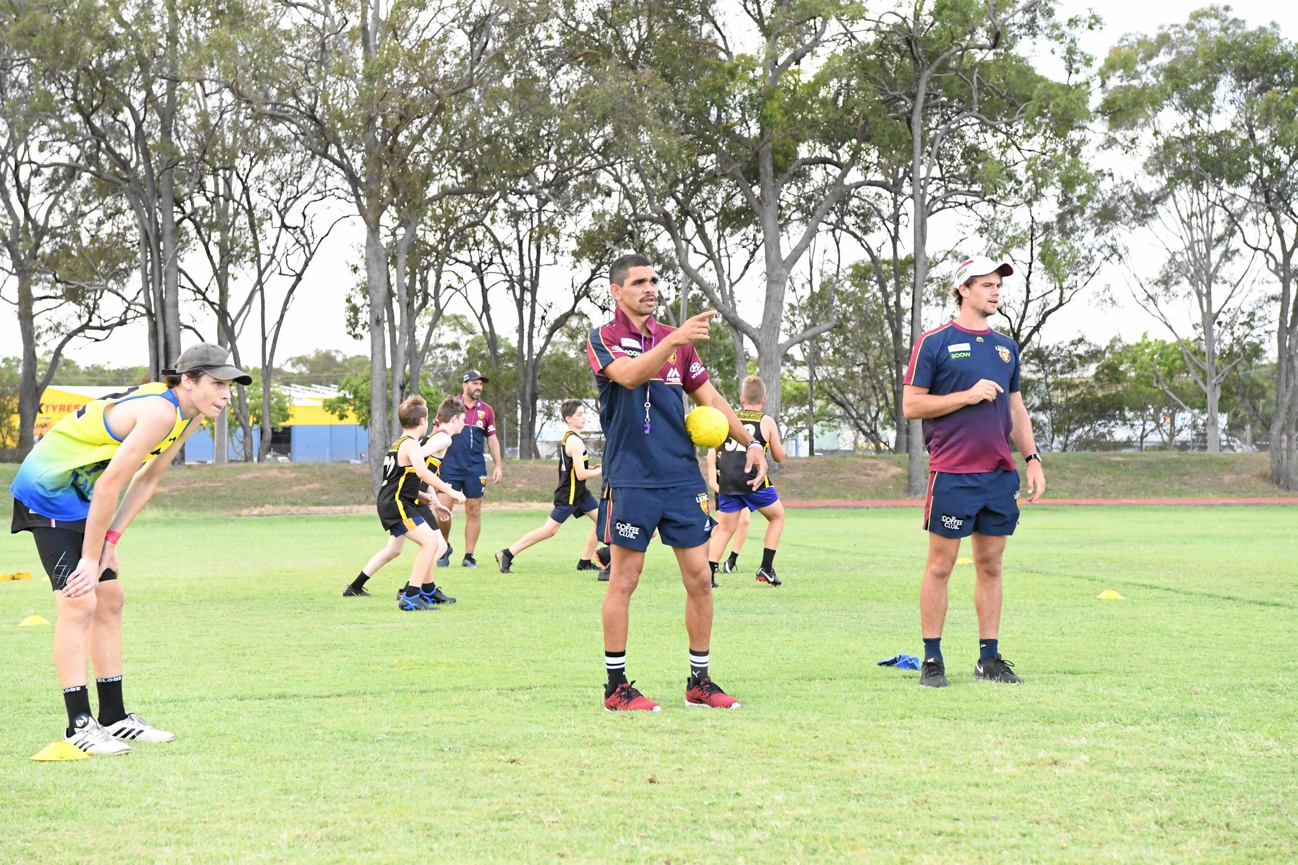 Brisbane Lion Charlie Cameron instructs the group he is teaching during a visit to Shalom College on Monday. He was here on a community camp with the club. Picture: Shane Jones