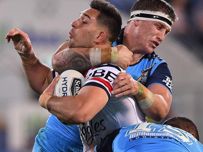 Jarrod Wallace of the Titans high tackles Ryan Matterson of the Roosters before being penalised during the Round 18 NRL match between the Gold Coast Titans and the Sydney Roosters at Cbus Super Stadium on the Gold Coast, Sunday, July 15, 2018. (AAP Image/Dave Hunt) NO ARCHIVING, EDITORIAL USE ONLY