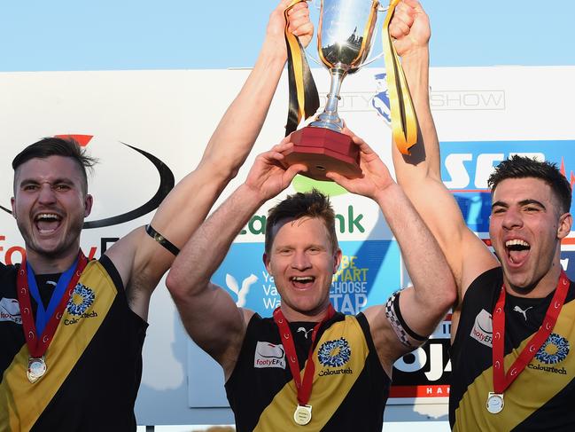 Jarrod Witnish (left) shows off Mitcham’s 2015 silverware. Picture: Andy Brownbill