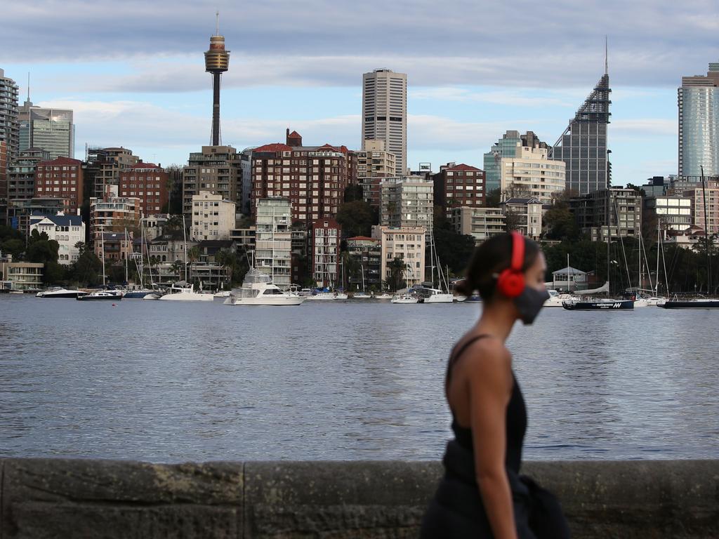 A woman exercising while wearing a face mask at Rushcutters Bay. Picture: Lisa Maree Williams/Getty Images
