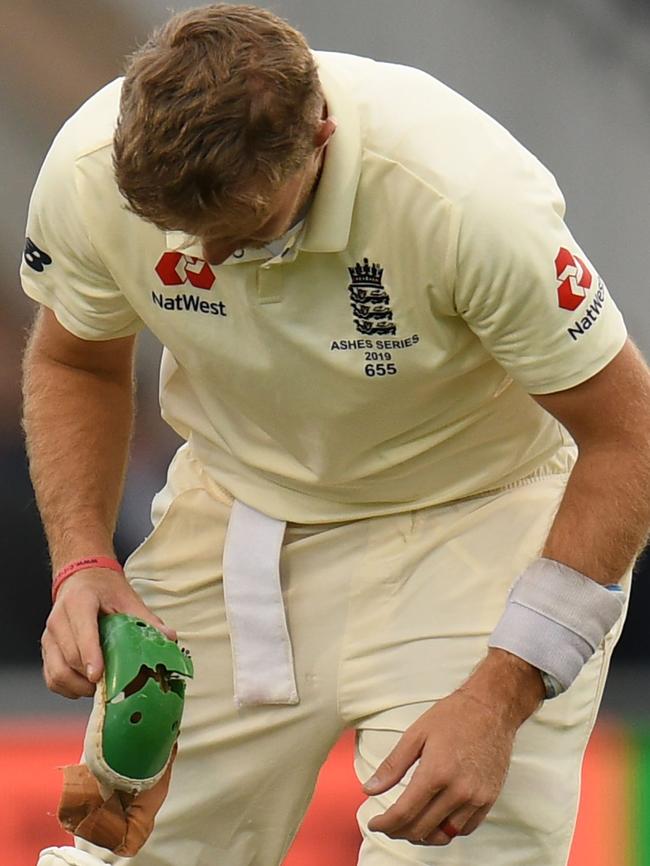 England captain Joe Root examines his broken protector. Picture: AFP