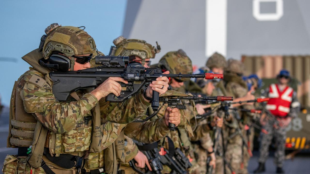 Soldiers from 3rd Battalion, the Royal Australian Regiment, and Royal Marines from Bravo Company, 40th Commando, conduct a weapon safety drill as part of a training serial on HMAS Canberra.