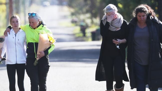 Friends of one of the crash victims arrive at the scene today. Picture: John Grainger