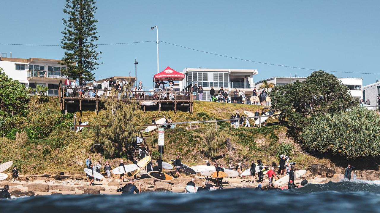 Hundreds lined the shore to pay tribute to Bill Carey during a paddle out at The Bluff at Alexandra Headland on May 21. Picture: Moment of Stoke