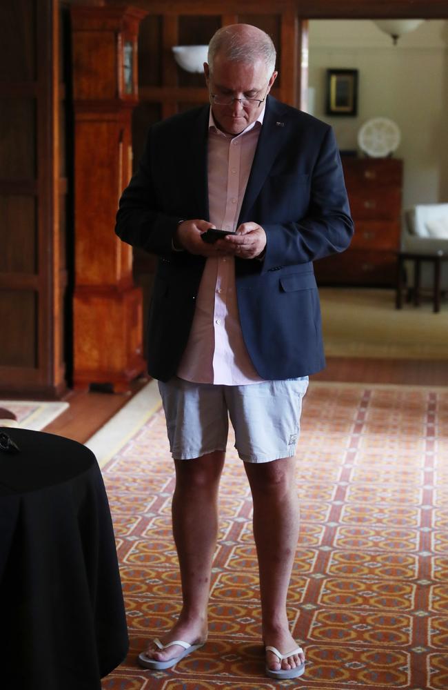 Prime Minister Scott Morrison is all of us in isolation – business shirt and jacket up top and shorts and thongs below. Picture: Adam Taylor