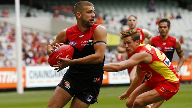 DEMON DAYS: Jimmy Toumpas evades Gold Coast’s David Swallow at the MCG. Picture: Michael Klein.