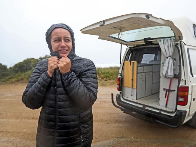 Camper Shannon Johnson of Melbourne braves the weather at Shelley Point, Scamander as she try's to find a safe place to camp overnight.   Picture: Zak Simmonds