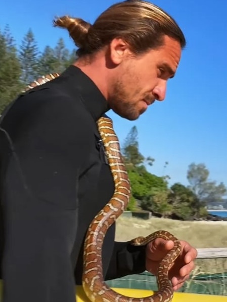 Surfer Higor Fiuza, who was filmed surfing with his pet snake, is under investigation by wildlife authorities. Picture: Instagram/ @skymonkey5