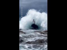 Man posing hit with a huge wave