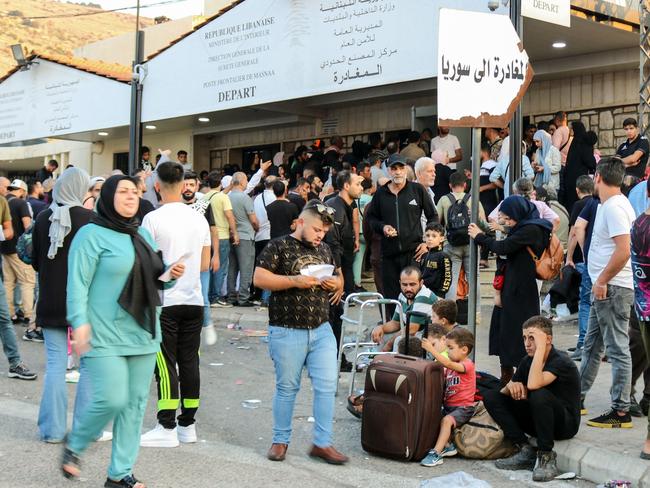 People fleeing Israeli bombings in Lebanon prepare to cross the border with Syria through the Masnaa crossing is eastern Lebanon. Picture: AFP.