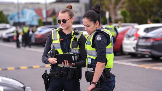 Constables Emma Whitfield and Brittany Adcock doing car checks in the carpark at Fountain Gate shopping centre in Narre Warren. Picture: Penny Stephens